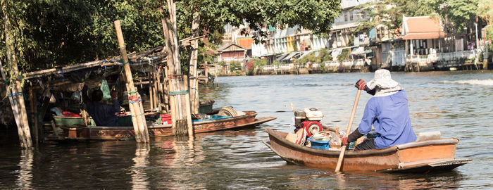 View of boats in canal along buildings