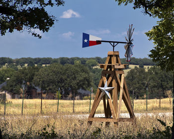 Traditional windmill on field against sky