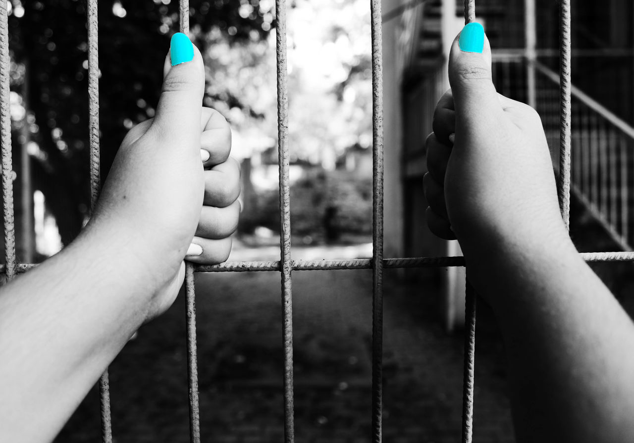 person, holding, close-up, part of, focus on foreground, human finger, outdoors, day, tall, balustrade