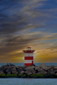Red lighthouse in den haag, the hague in netherlands with a sunset as background.