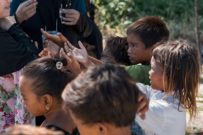 Rear view of people holding family