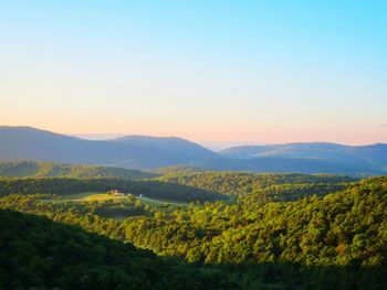 Scenic view of mountains against clear sky during sunset