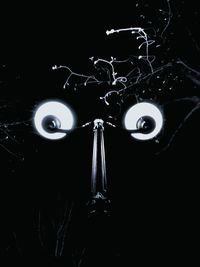 Close-up of electric lamp against black background