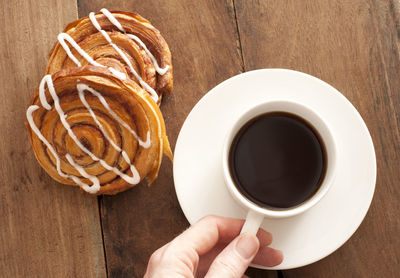 Cropped image of man holding coffee cup