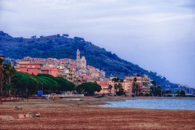 Scenic view of buildings and mountains against sky