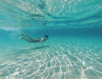 Low section of person swimming in sea