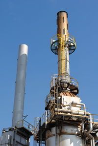 Low angle view of smoke stack against sky
