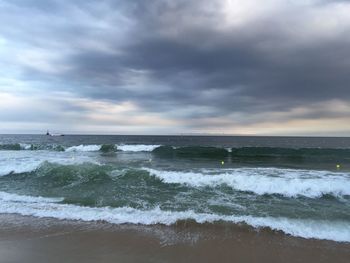 Scenic view of sea against cloudy sky