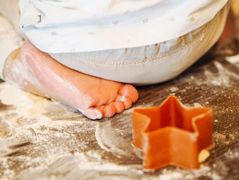 Boy siiting on a table with flour and cookie star