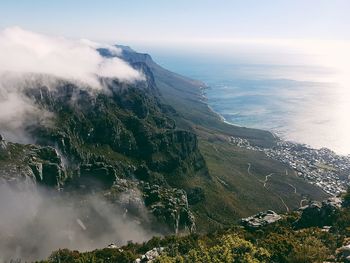 High angle view of sea and mountains against sky