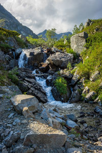 Scenic view of waterfall against sky