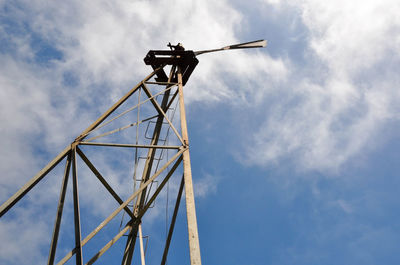 Low angle view of telephone pole against sky