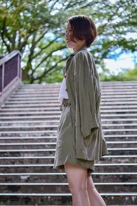 Rear view of woman standing on staircase