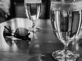 Close-up of wine glasses on table