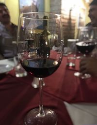 Close-up of wine glasses on table in restaurant