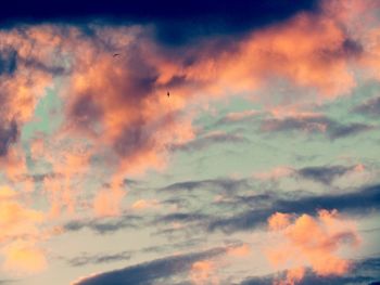 Low angle view of cloudy sky at sunset