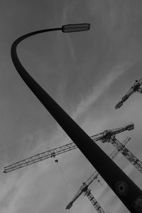 Low angle view of crane against sky