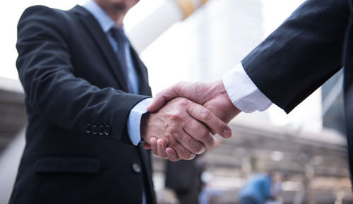 Close-up of business people shaking hands