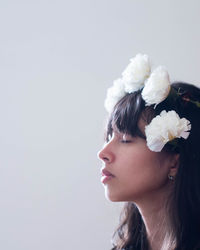 Woman with flowers against white background