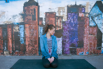Woman on wall in city