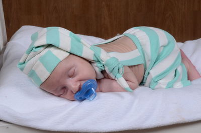 Close-up of baby sleeping in bed