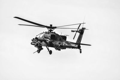 Low angle view of helicopter flying against clear sky