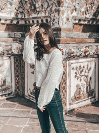 Woman standing against wall