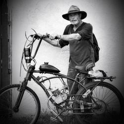 Portrait of man standing with bicycle