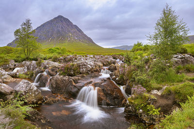 Scenic view of waterfall against sky