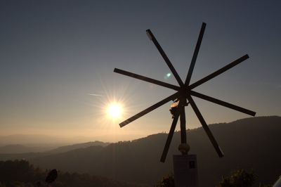 Silhouette of windmill at sunset