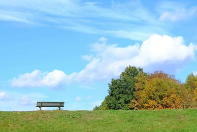 Scenic view of grassy field against cloudy sky