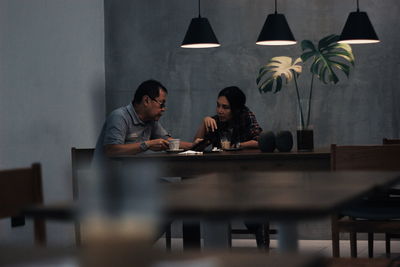 Men sitting on table at home