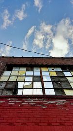 Low angle view of building against cloudy sky