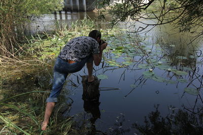 Reflection of man in lake