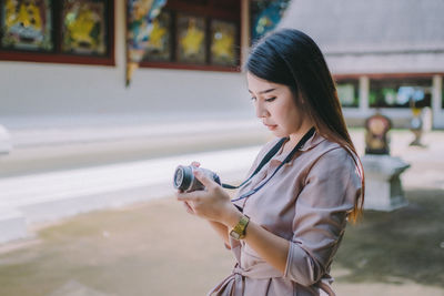 Woman looking at camera in city