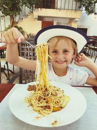 Portrait of cute girl with food on table