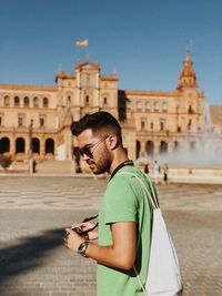 Full length of man standing in city against sky