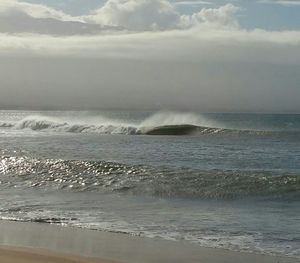 Scenic view of sea against cloudy sky