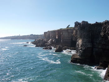 View of built structure by sea against clear sky