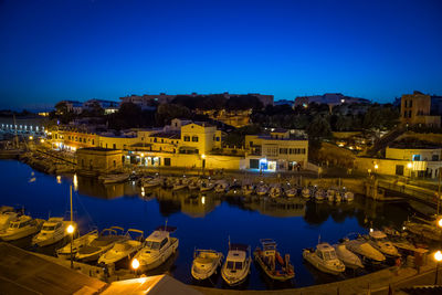 High angle view of illuminated buildings against sky at night