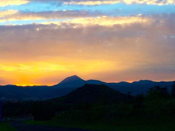 Scenic view of mountains against sky at sunset