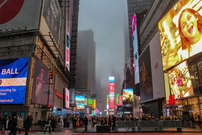 People on city street amidst buildings