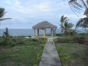 Built structure by sea against sky