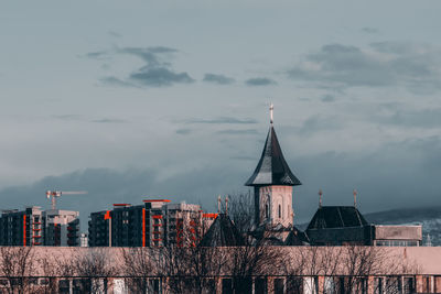 Roof of church and tall buildings in the distance in iasi, romania
