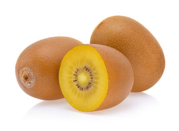 Close-up of kiwi fruits against white background