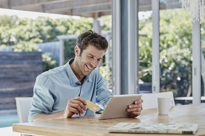 Man doing online payment from digital tablet with credit card