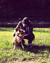 Portrait of man with dog on grass