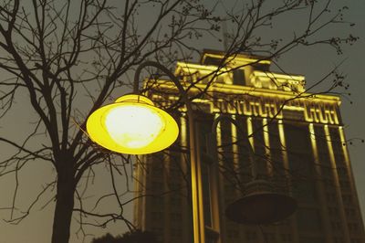 Low angle view of illuminated street light against sky