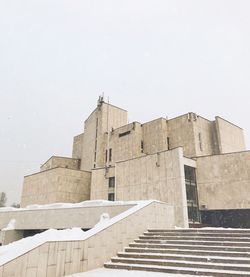 Low angle view of building against sky during winter