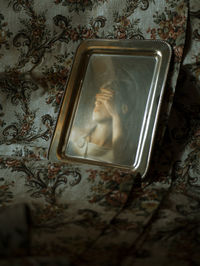 Close-up of mobile phone on bed against wall